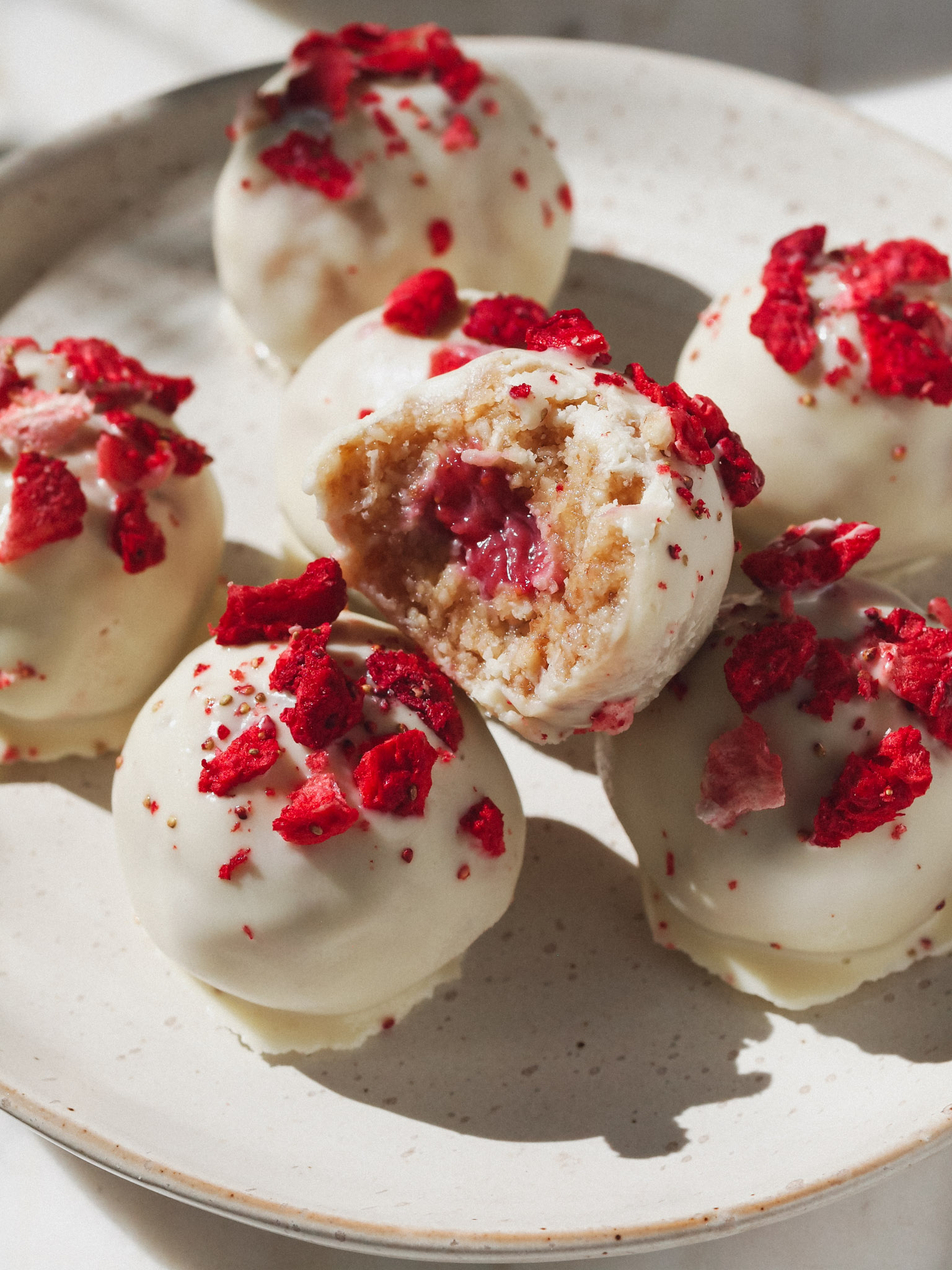 Strawberries and Cream Healthy Raw Vegan Bliss Balls with Strawberry Filling